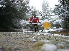 Person with bike standing on snowy road